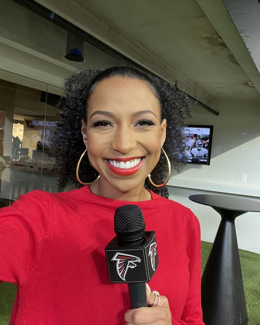 Chelsea in red with a Falcons mic inside Mercedes-Benz Stadium